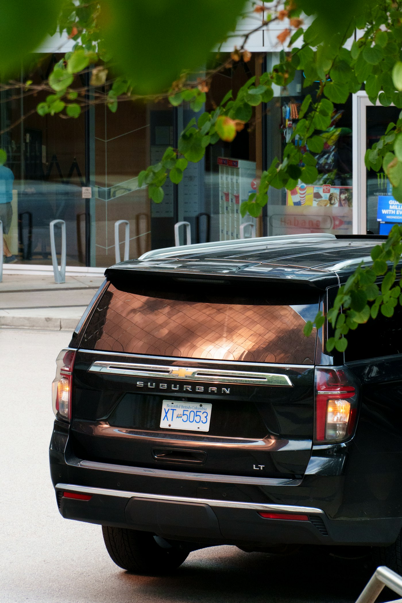 Rear of a black Chevrolet Suburban showing the Suburban badge